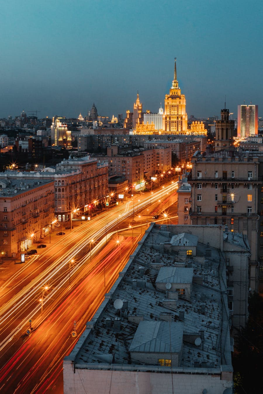 Night cityscape with bright traffic light trails.