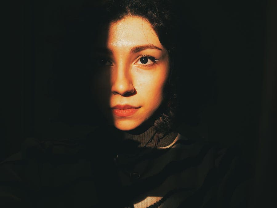 Portrait with a warm beam of light across the face.